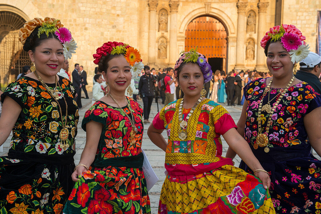 Women posing dressed in regional costumes in the city of Oaxaca de Juarez, Oaxaca, Mexico.