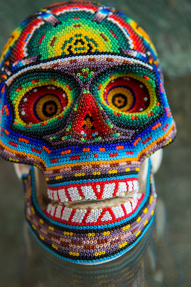 A skull covered with glass beads on display in an art gallery in Oaxaca City, Mexico.