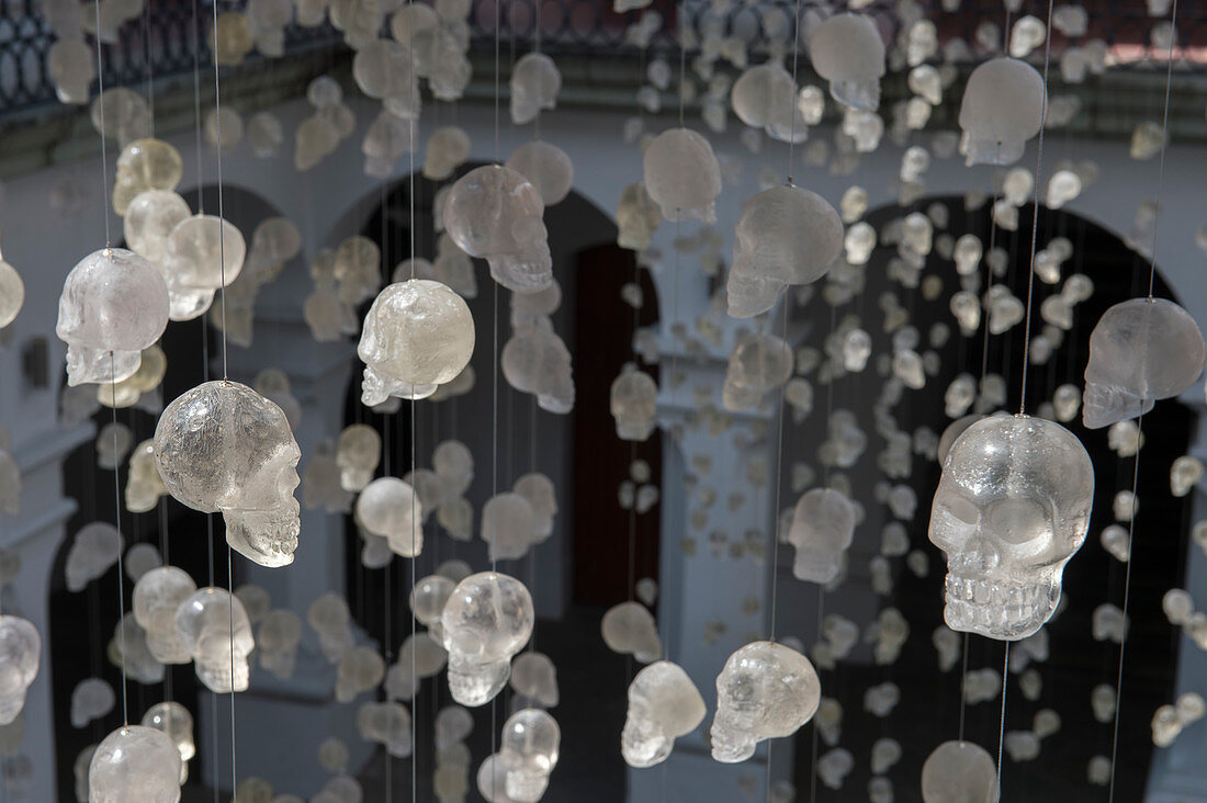 Glass skulls hanging on strings in the courtyard of the Museo de los Pintores Oaxaquenos in Oaxaca City, Mexico.