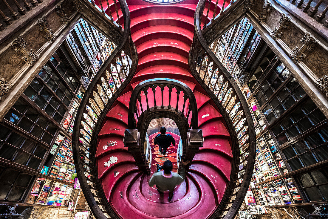 Curved wooden staircase in library, Livraria Lello & Irmão bookstore, Porto, Portugal, Europe