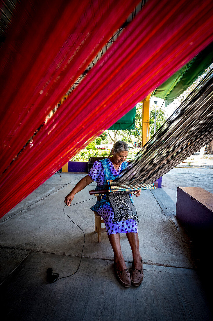 Indigenous women working handcrafted yarn in the state of Oaxaca in Mexico