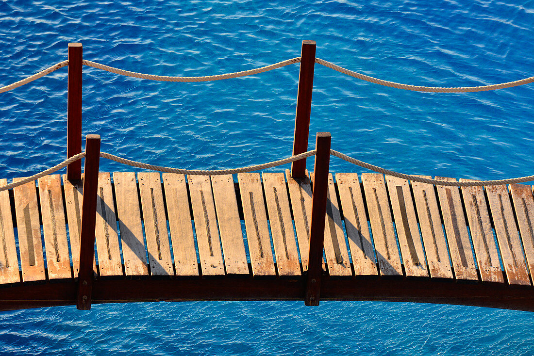 A small wooden bridge leads over a swimming pool, Castellon de la Plana, Spain