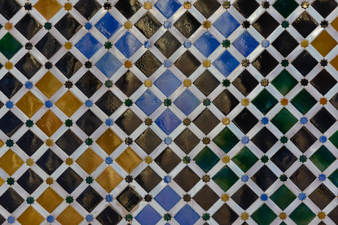 Colorful pattern on the tiles of a wall in the Alhambra, Granada, Andalusia, Spain