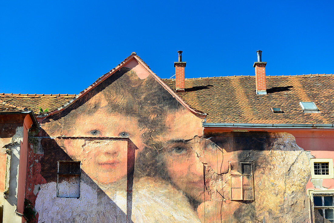 House facade artistically painted with faces, Zagreb, Croatia