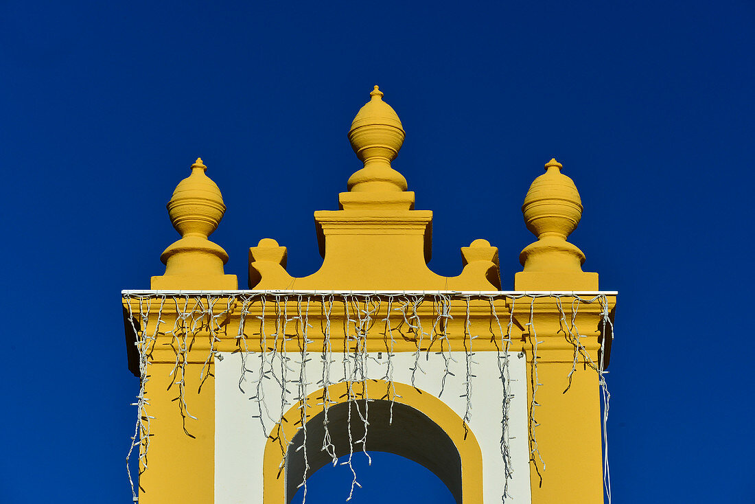 View of the yellow and white church with fairy lights, Luz, Algarve, Portugal