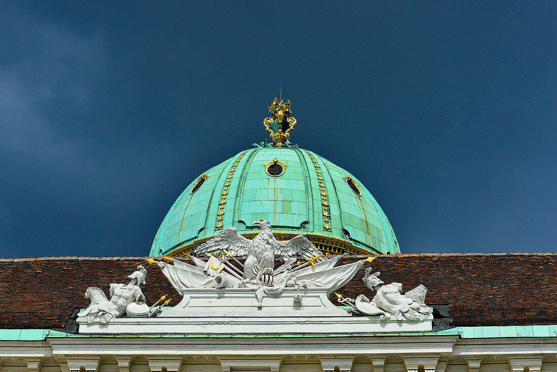 Gold ornate dome and ornaments on the roof of an old building in Vienna, Austria