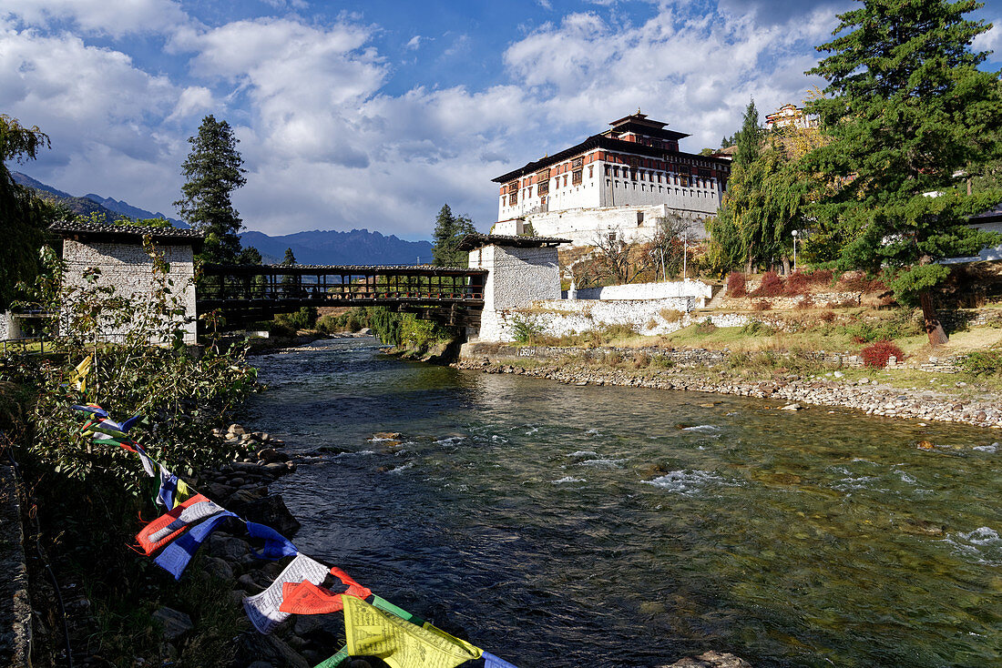 A wooden bridge leads over to the entrance to the Dzong of Paro.