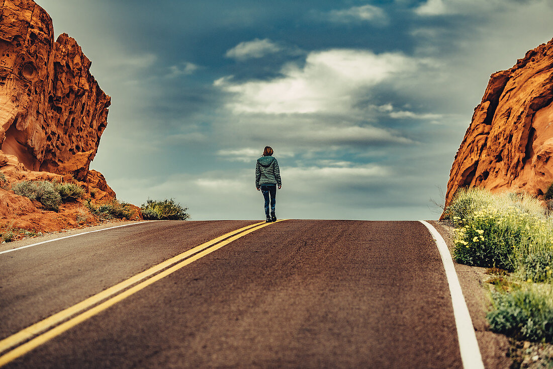 Woman running on road in Valley of Fire State Park, Las Vegas, Nevada, USA, North America, America