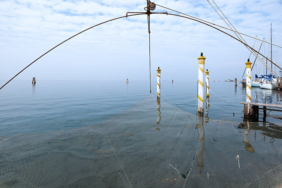 View of the Venice lagoon from the port of Pellestrina, in the foreground a fishing net, Pellestrina, Veneto, Italy, Europe