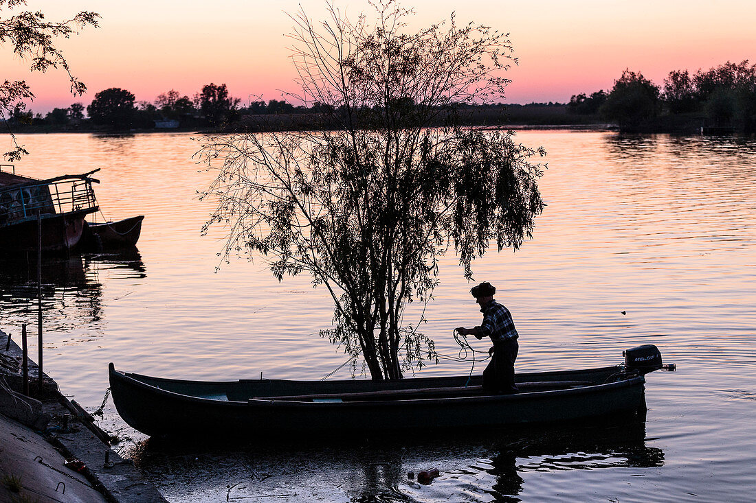 A fisherman in the Danube Delta casts at dusk, Mila 23, Tulcea, Romania.
