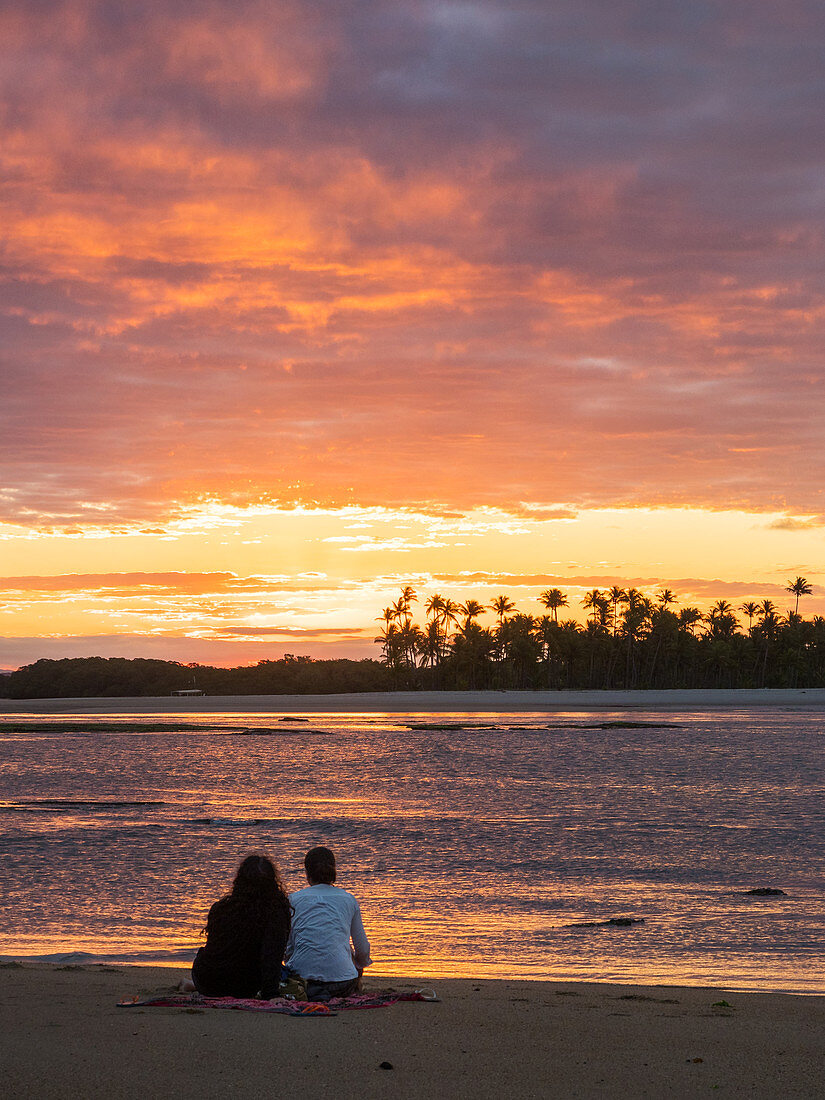 Couple at sunset on the beach with palm trees, Boipeba Island, Bahia, Brazil, South America