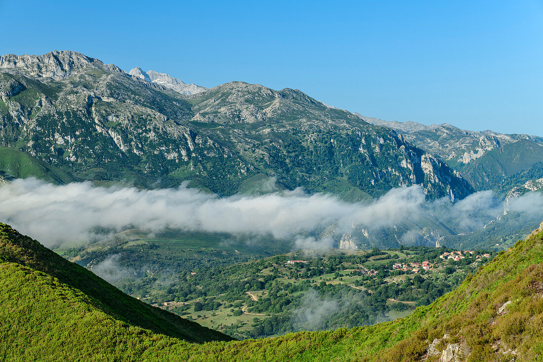 View of Picos de Europa with foggy mood in the valley, from Picu Tiedu, Picos de Europa, Picos de Europa National Park, Cantabrian Mountains, Asturias, Spain