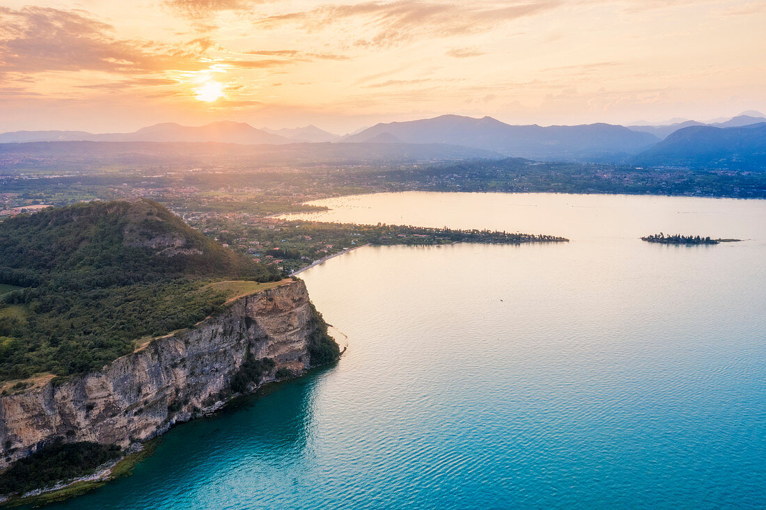 Aerial shot of the Rocca di Manerba, in the background you can see the Gulf of Manerba and the island of San Biagio. Manerba, Garda Lake, Province of Brescia, Italy
