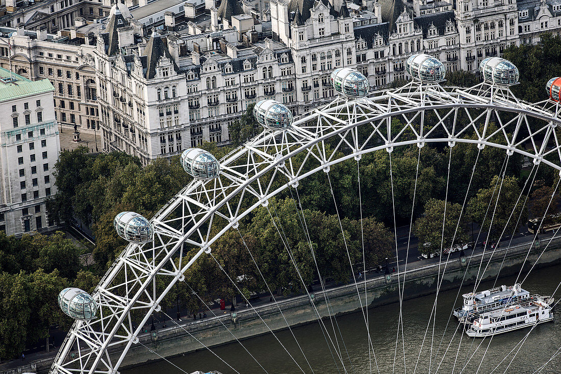 Aerial view of the London Eye and passenger pods above the river Thames.
