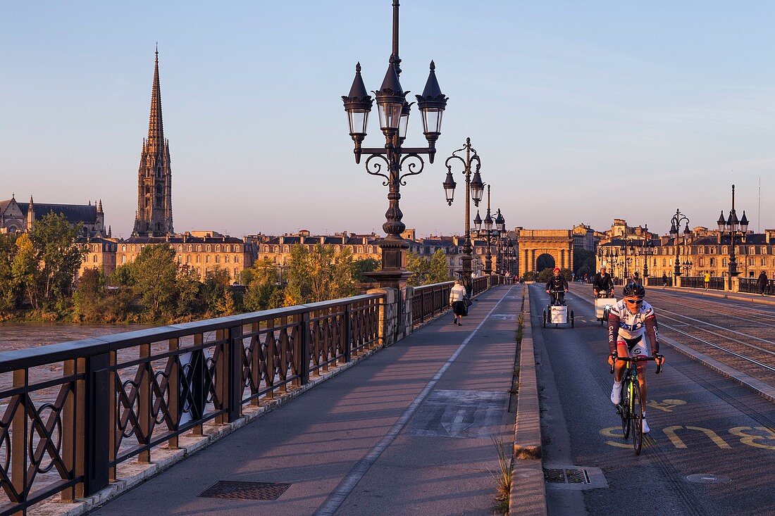 France, Gironde, Bordeaux, area listed as World Heritage by UNESCO, Pont de Pierre on the Garonne River, in the background Saint Michel church and the gate of Bourgogne