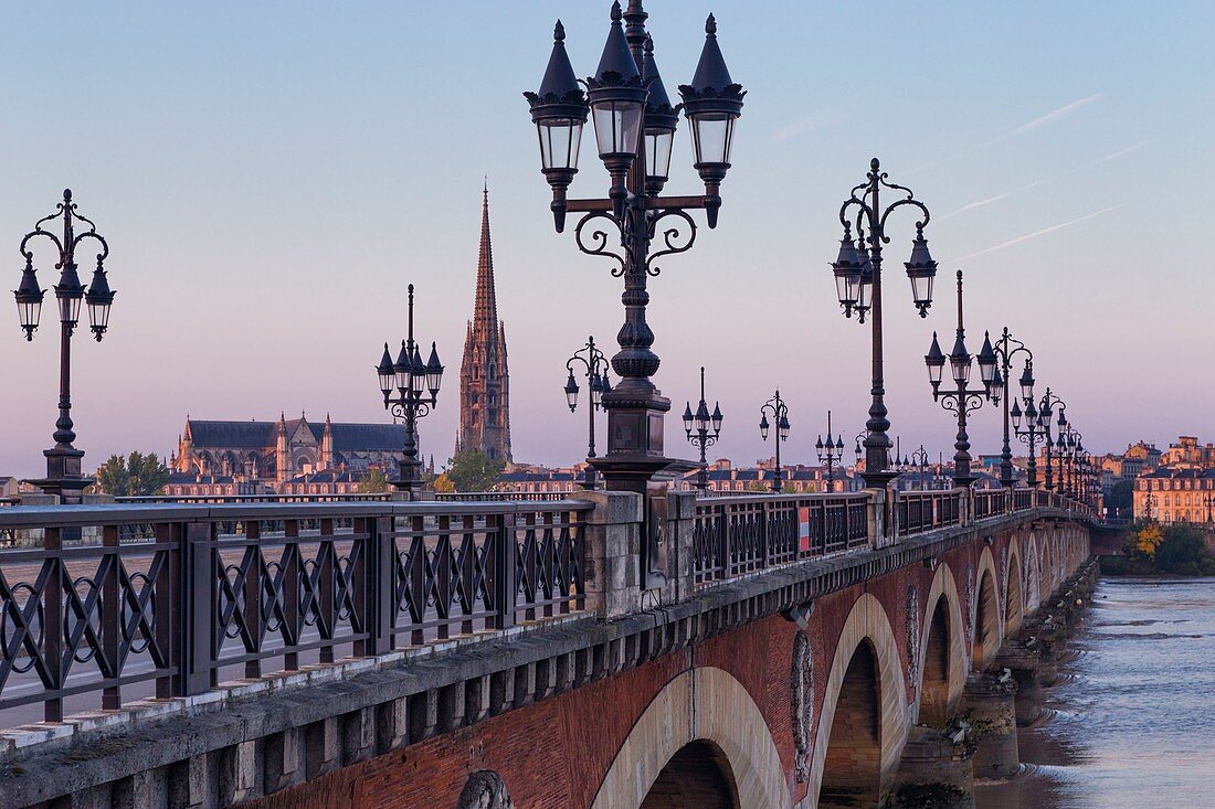 France, Gironde, Bordeaux, area listed as World Heritage by UNESCO, Pont de Pierre on the Garonne River, in the background Saint Michel church and the gate of Bourgogne