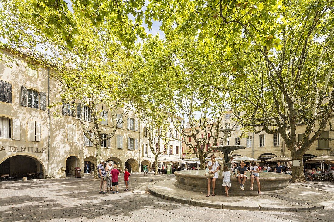 France, Gard, Pays d'Uzege, Uzes, the Place aux Herbes surrounded by arcaded houses and its outdoor cafes