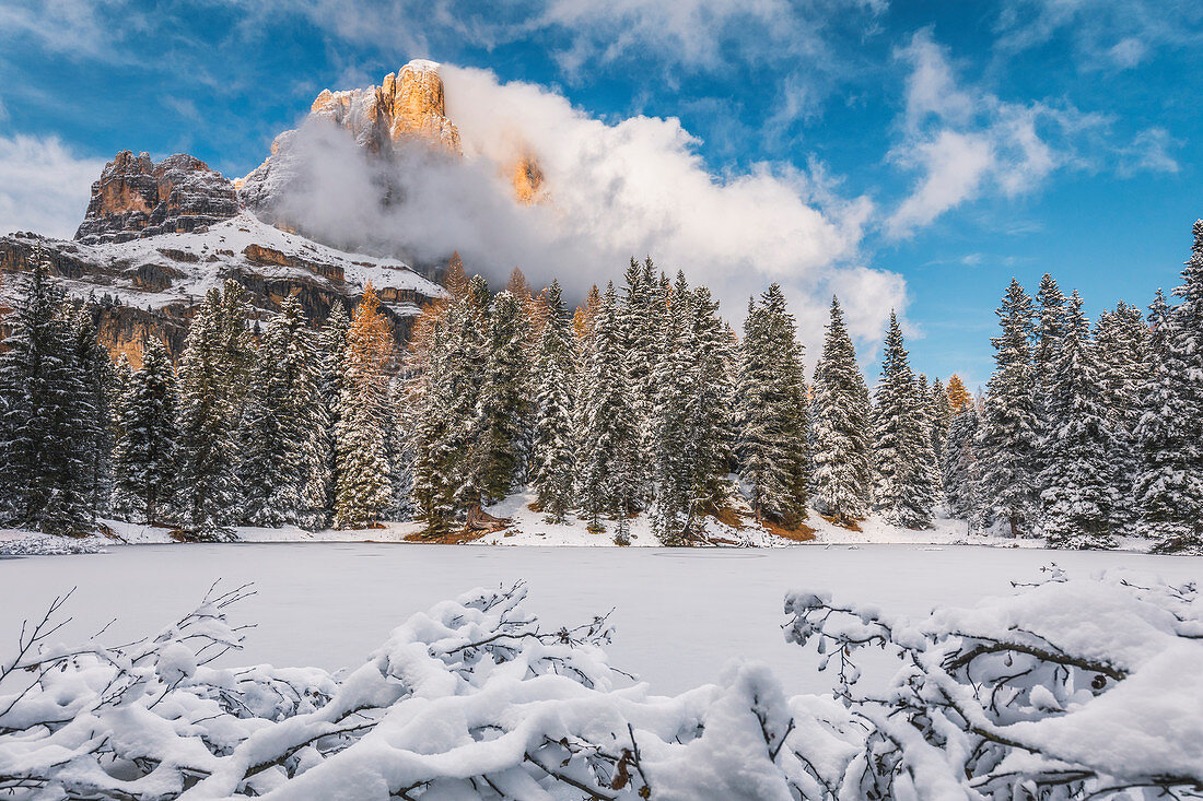 the small lake of Bain de Dones after the snowfall, in the background the Tofana di Rozes, Dolomites, Cortina d'Ampezzo, Belluno, Veneto, Italy