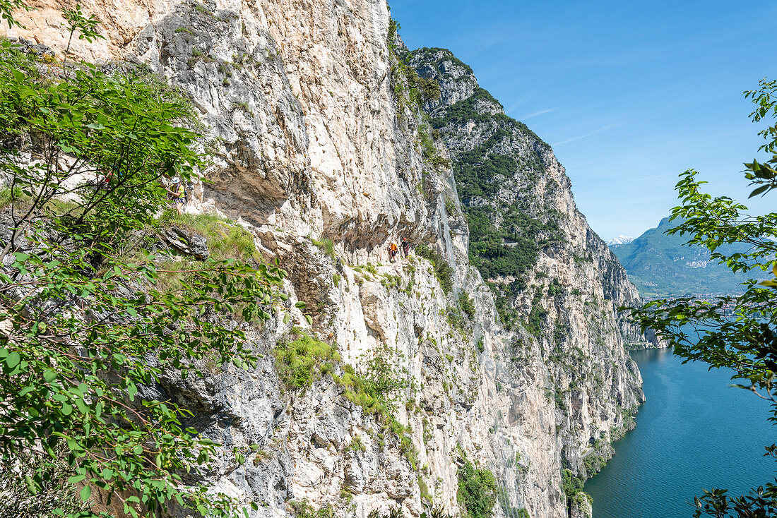 Pregasina, Riva del Garda, Lake Garda, Trento province, Trentino Alto Adige, Italy, Europe. Climbers on the "Via dei Contrabbandieri" (also named Via Torti) high above the Garda Lake