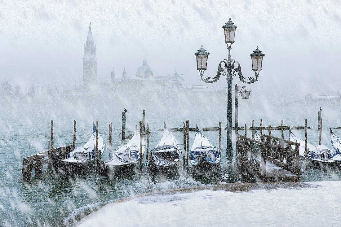 Snowy Venice, a rare snowfall in Riva degli Schiavoni with St. George's island in the background, Venice, Veneto, Italy