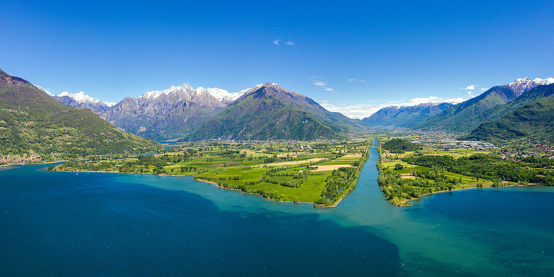 Aerial panoramic of river Adda flowing into the blue Lake Como, Trivio di Fuentes, Lower Valtellina, Lombardy, Italy