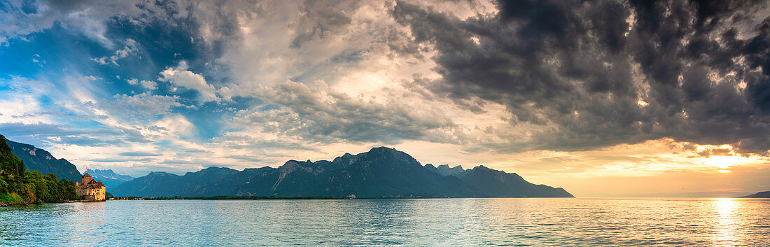 Panoramic of clouds at sunset on Lake Geneva and Chillon Castle (Chateau de Chillon), Veytaux, Montreux, Canton‎ Vaud, Switzerland
