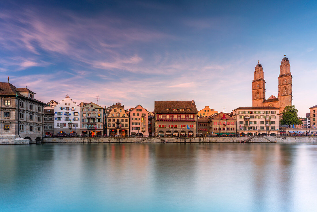 Sunset over the old buildings of Limmatquai and Grossmunster Cathedral, Zurich, Switzerland