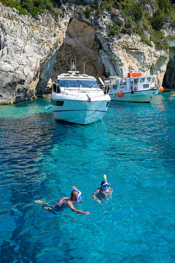 Tourists snorkelling at the Blue Caves, Paxos, Ionian Islands, Greek Islands, Greece, Europe