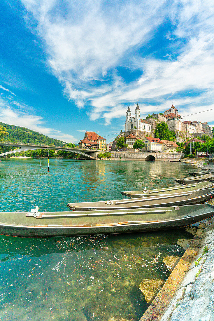 Boats moored in Aare River with Aarburg Castle in background, Aarburg, Canton of Aargau, Switzerland, Europe