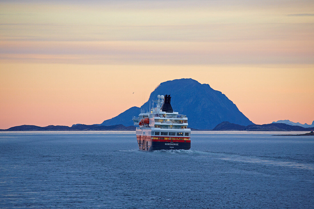 Encounter with the Hurtigruten ship Nordnorge at dawn, Rödöyfjord, Helgeland coasts, Nordland, Norway, Europe