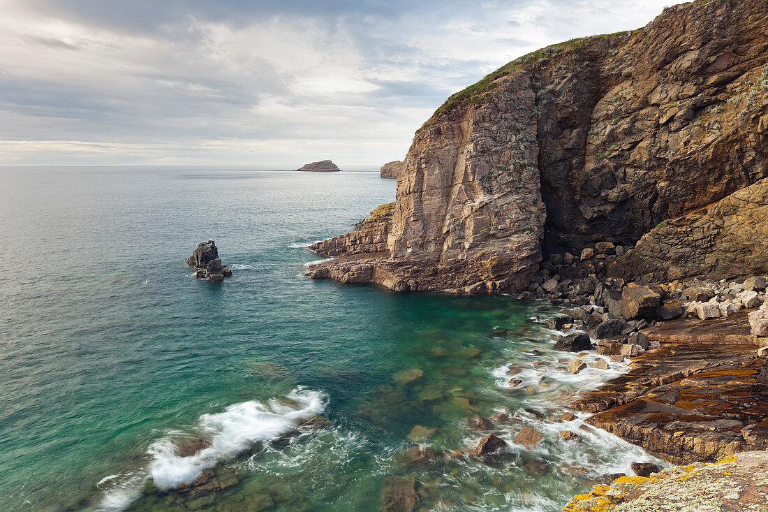 The emerald-colored sea laps the rocks at Cap Frehel.