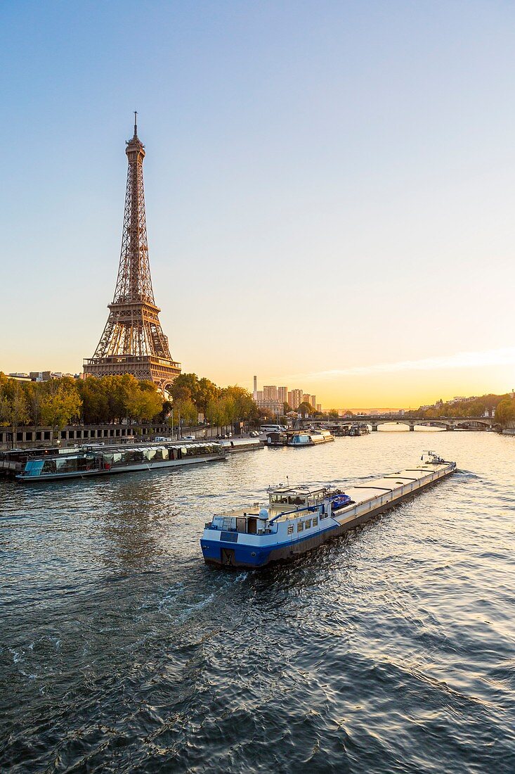 France, Paris, area listed as World Heritage by UNESCO, a freight barge and the Eiffel Tower