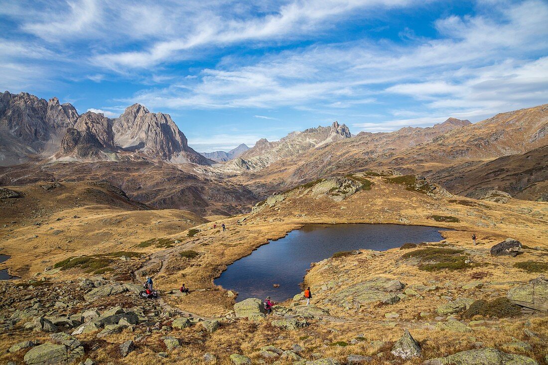 France, Hautes Alpes, Nevache, Claree valley, hikers on the Rond Lake trail, in the background the Pointe des Banchets (2953 m)