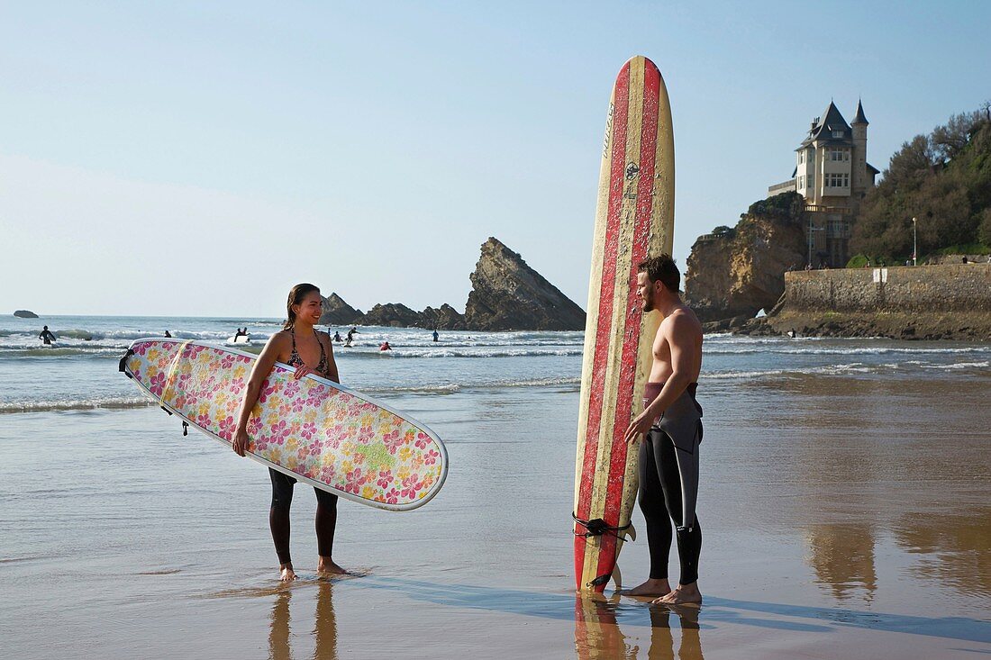 France, Pyrenees Atlantiques, Pays Basque, Biarritz, couple of surfers on the beach of the Basques coast beach