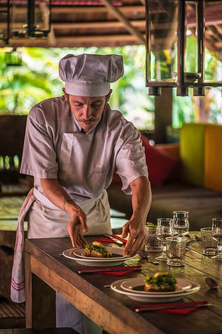 France, French Guiana, Kourou, Chef preparing a gourmet lunch at the Wapa Lodge without running water or electricity