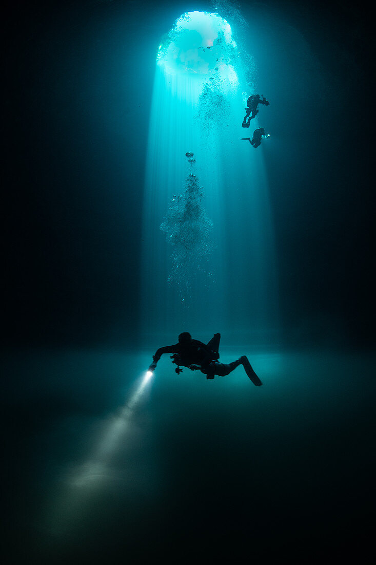 Divers exploring Cenote Maravilla,Mexico