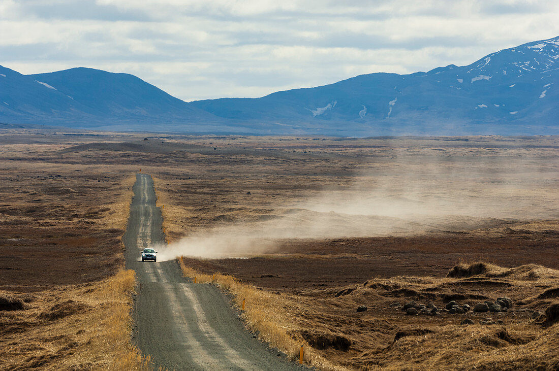 Vehicle leaving trail of dust on gravel road,Dettifoss,Iceland