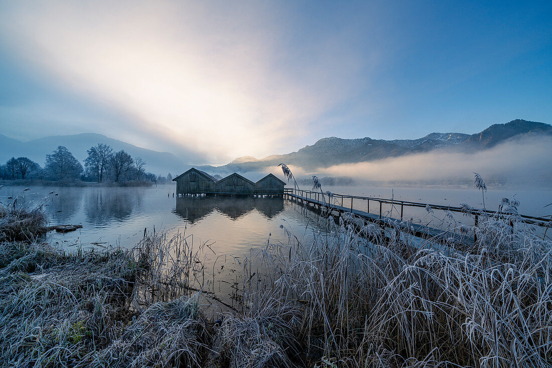 Three fishing huts on the Kochelsee in the morning light near Schlehdorf, Bavaria, Germany.