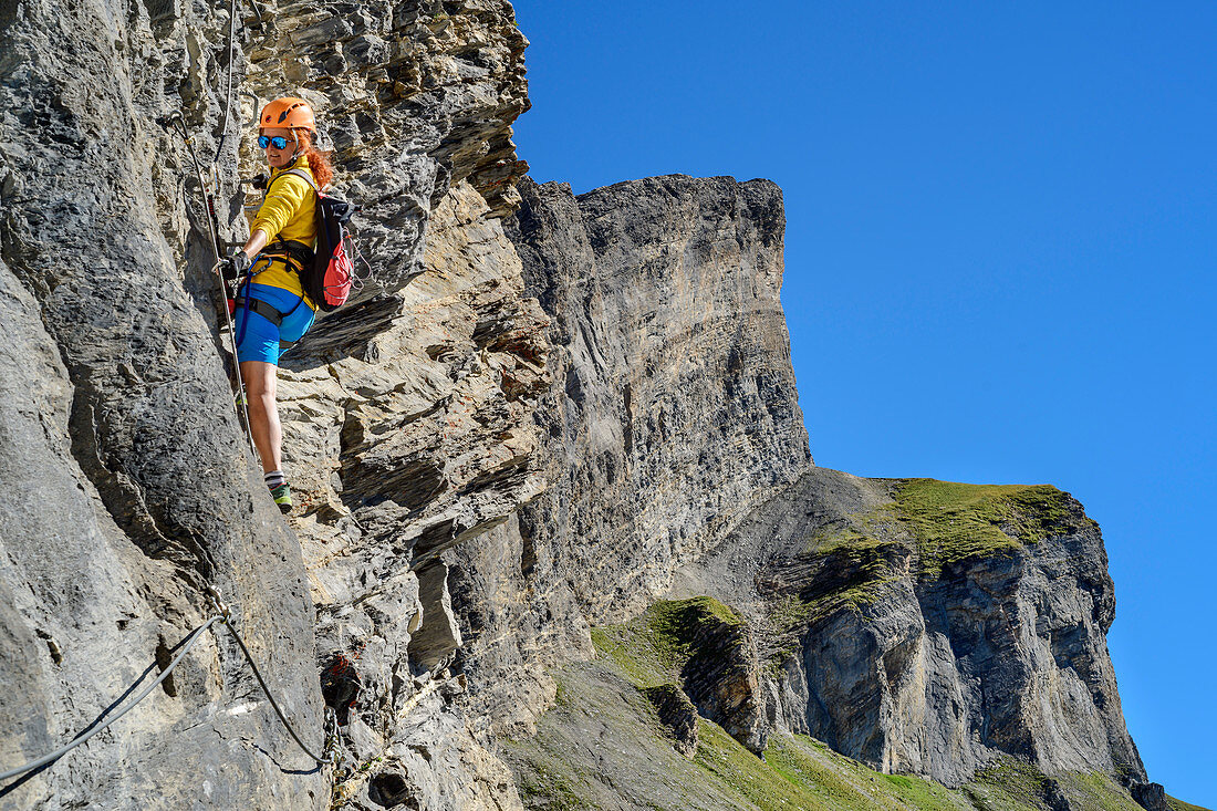 Woman climbs on the Gemmi adventure via ferrata, Gemmi, Bernese Alps, Valais, Switzerland