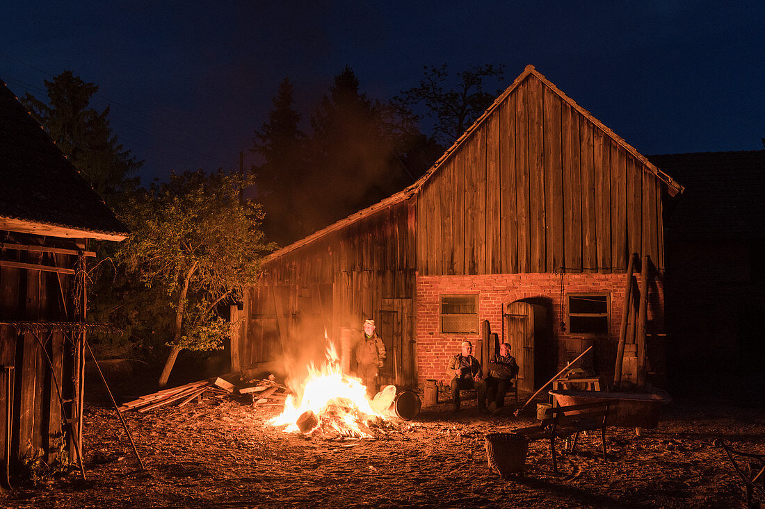Campfire in front of old barn, Germany, Brandenburg, Spreewald