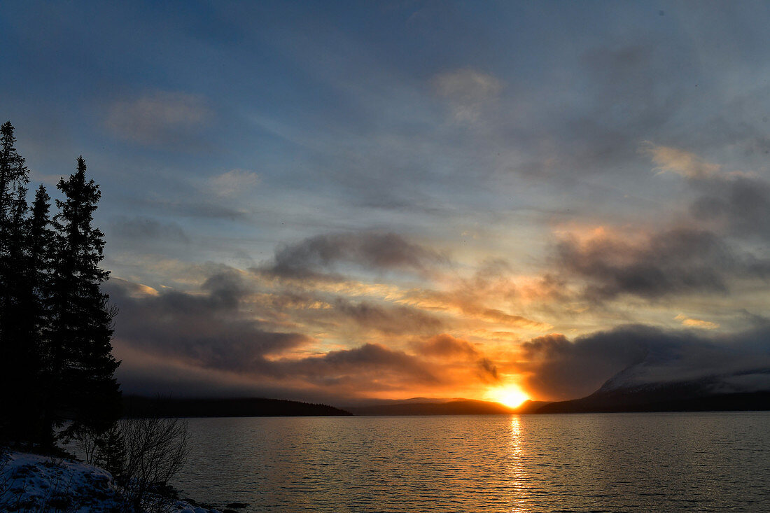 The sun rises over a lake, Risbäck, Lapland, Sweden