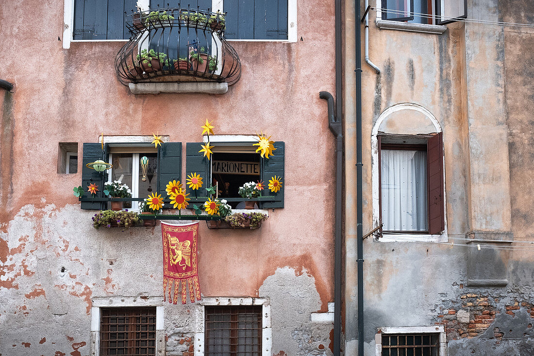 View of a facade amit decorated windows in Cannaregio, Venice, Veneto, Italy, Europe
