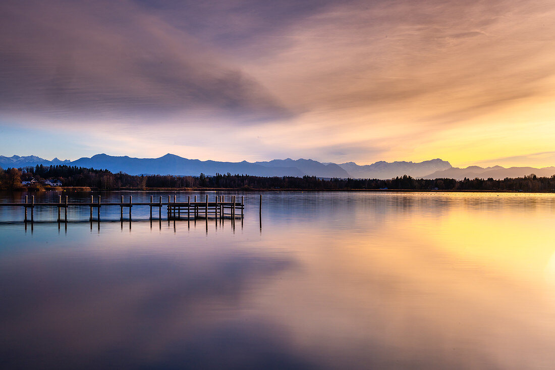 Jetty on Lake Starnberg at sunset with a view of the mountains, St. Heinrich, Bavaria, Germany