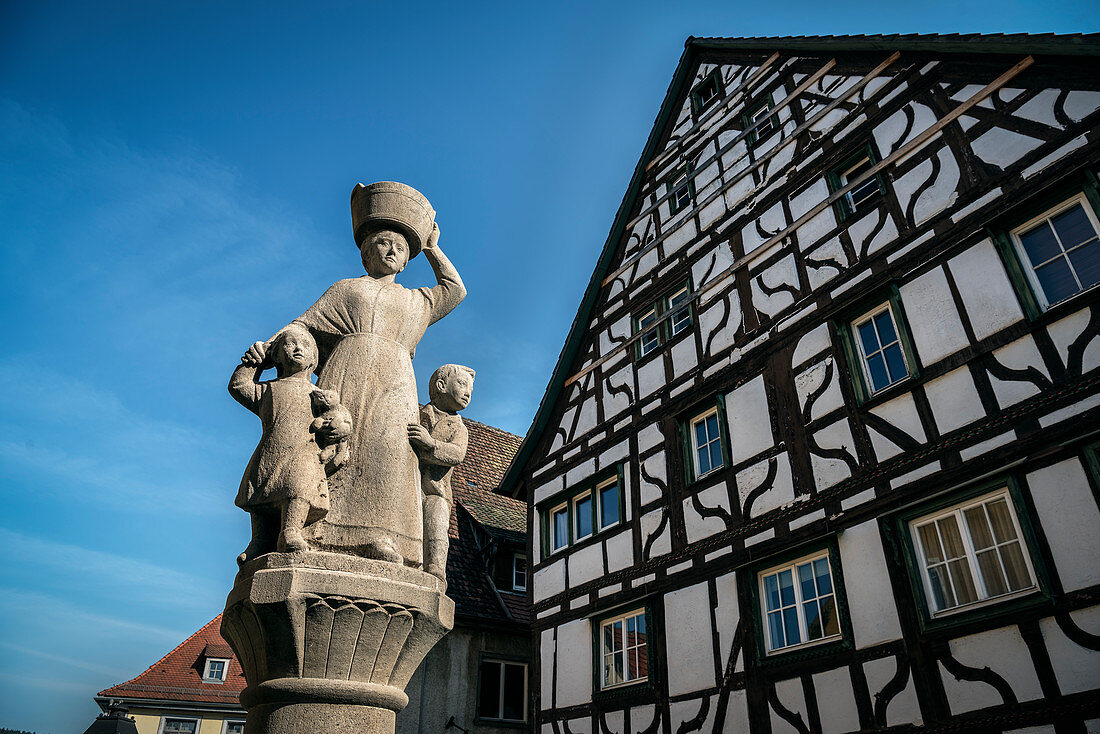 Fountain sculpture and half-timbered houses in the upper town of Mühlheim an der Donau, Baden-Württemberg, Germany