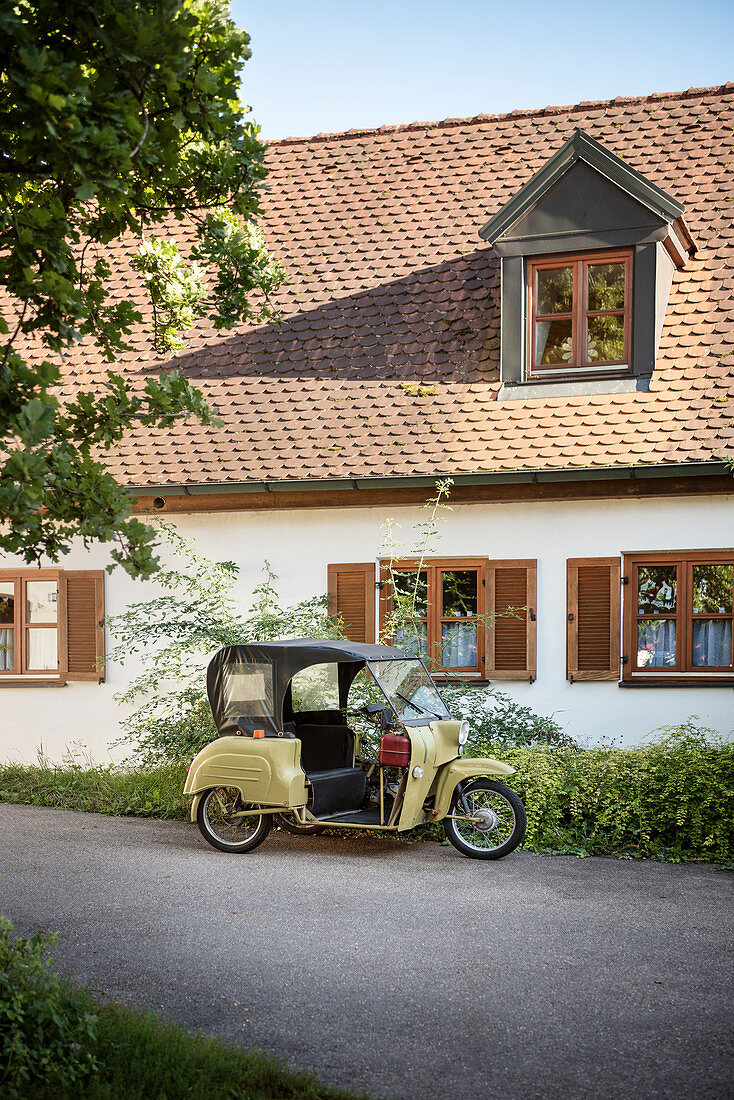 historic tricycle motorcycle in the alleys of the old town of Neuburg an der Donau, district of Neuburg-Schrobenhausen, Bavaria, Germany
