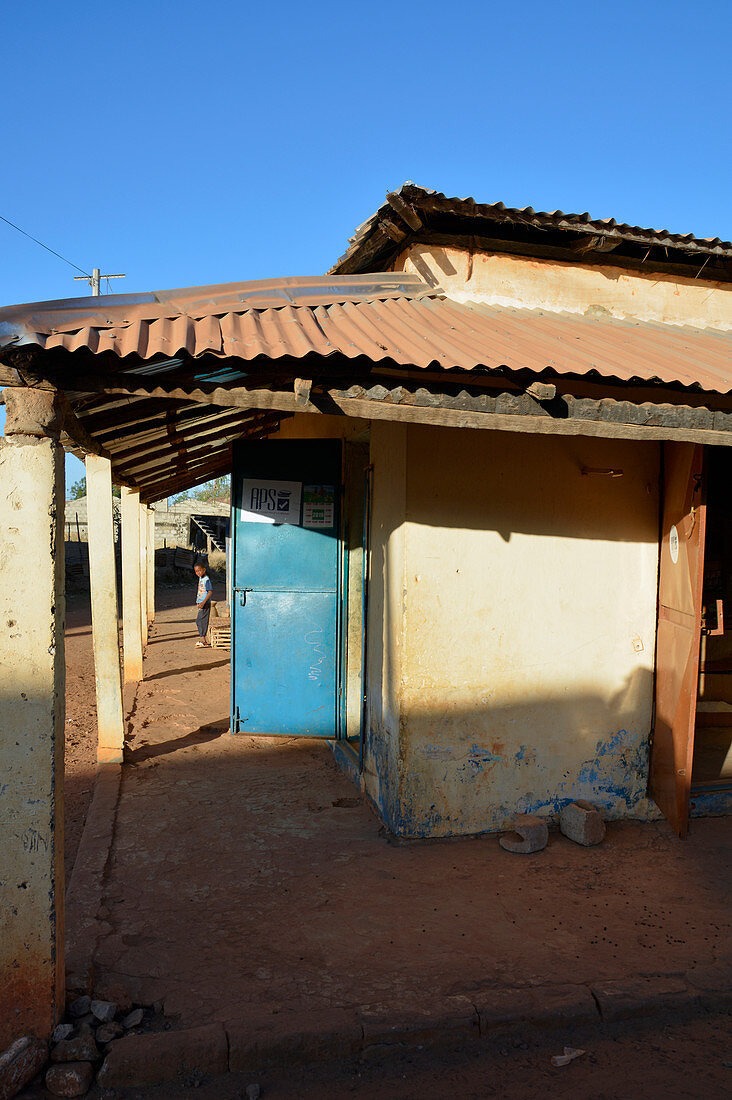 Gambia; Central River Region; Kuntaur; Shop building on the main street; Boy in the background is watching us