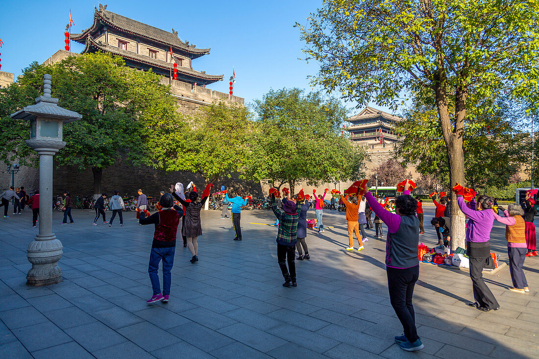 Locals performing Tai chi near City wall of Xi'an, Shaanxi Province, People's Republic of China, Asia