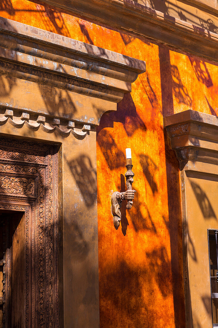 Close up of lamp and door frame of a building in Todos Santos, Mexico.