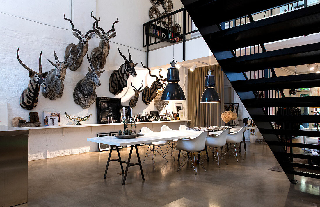 Interior shot of an artists home in Copenhagen. Walls decorated with painted taxidermied animals.