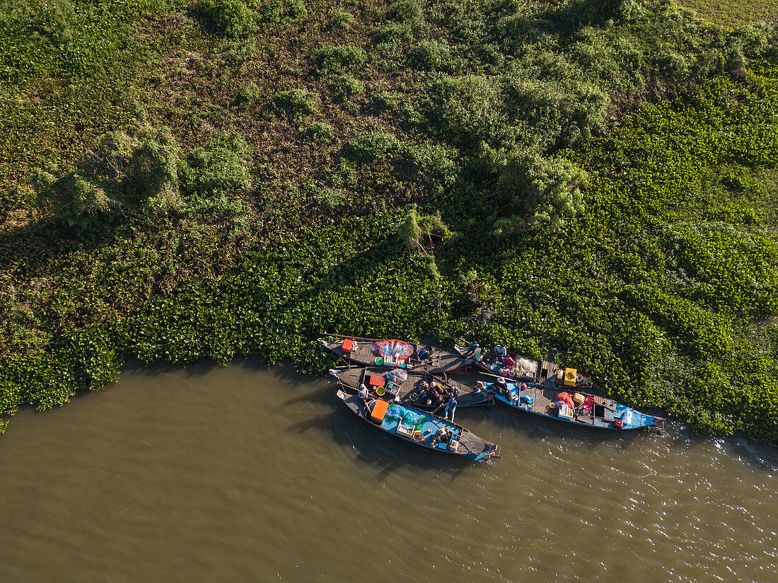 Aerial view of fishermen on a group of longtail boats along the banks of the Tonle Sap River, near Kampong Chhnang, Kampong Chhnang, Cambodia, Asia
